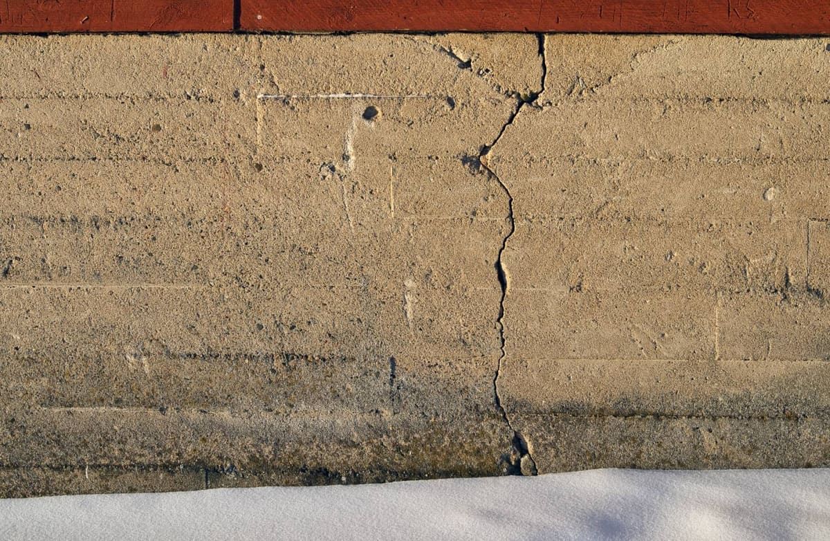 Vertical crack running through a concrete foundation wall